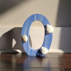 Wooden O with sea shells